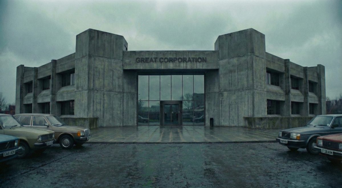 Great Corporation: a grey concrete headquarters under a grey sky, an empty forecourt of 1970s cars